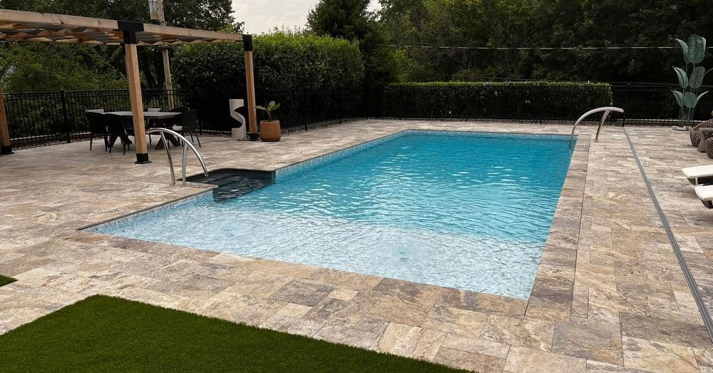 Brick home with green grass and a blue cloudy sky